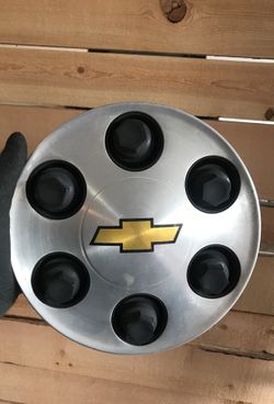 Two Chevy lug nut covers