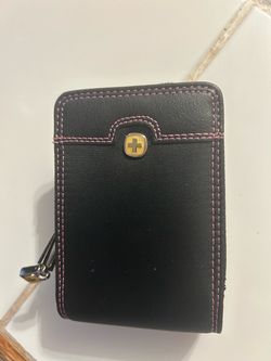 black Wenger The Rhea small camera case accented with distinctive pink stitching and the brand's signature gold-toned cross logo.