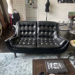 Vintage MCM Black Leather Sofa and Loveseat Mid Century Modern Furniture. In good condition, but the sofa needs the leg to be fixed or held up with bo
