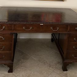 Antique desk manufactured in London by a hunt and company. Comes apart in three pieces for easy transportation. Leather top. Excellent condition. Plea