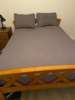 Solid Wood Double/Full Bed Frame with Mattress with quilted gray bedspread and pillow shams