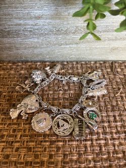 vintage sterling silver charm bracelet adorned with multiple detailed dangling charms