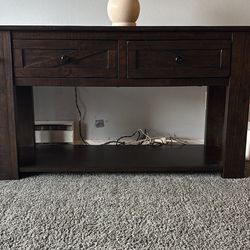 Two solid wood tables in rustic dark wood
