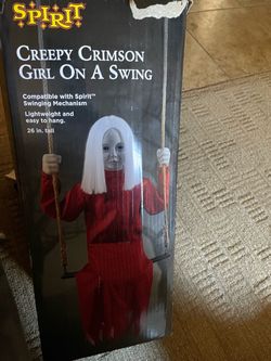 Creepy scary girl on swing