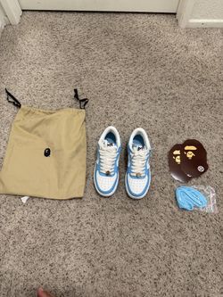 Blue and white Bape-style sneakers with extra laces and dust bag.