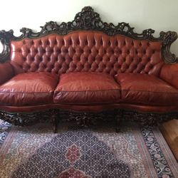 GORGEOUS antique leather couch from Italy. With hand carved wood trim