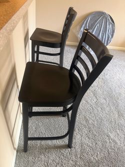 Tall black wooden barstools