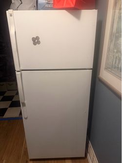 Refrigerator and top freezer
