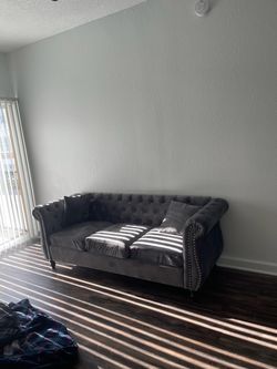 Grey Chesterfield-style sofa.