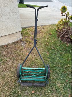 Four blade manual walk behind reel lawn mower