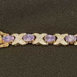NWOT Bracelet with Purple Stones & Crystals. 7.5” Gold Color Setting.