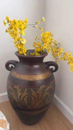 Brown pot with yellow flowers