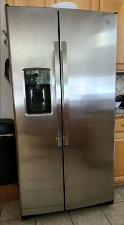GE Refrigerator.  25.3 cu ft stainless steel, side by side with ice & water in the door