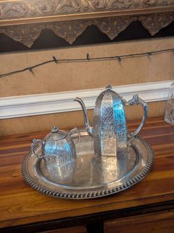 Elaborate engraved design plated silver creamer and sugar bowl with tray