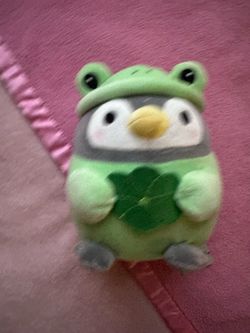 Takashoji penguin plush dressed in a green frog costume & holding a lucky clover leaf ⋆. 𐙚 ˚