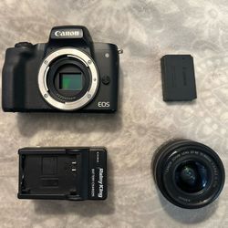 Canon EOS M50 camera with lens, battery, and charger