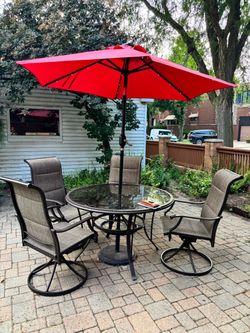 Back yard table with chairs and umbrella