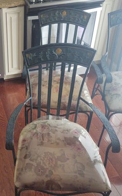 Set of four (4) wrought iron chairs.