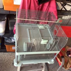 Full Cheeks Modern multi tier pet hamster cage with bottom part that easily slides out for faster more efficient. Comes with food container and water 