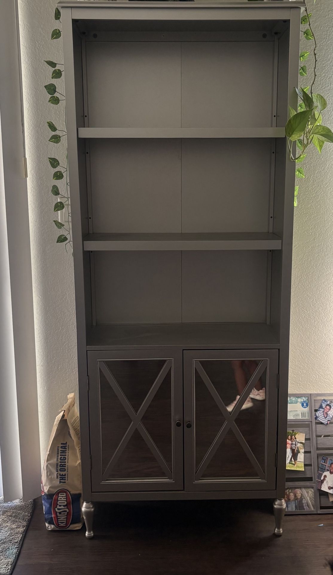 Gray Book Shelf With Mirrored Cabinet Doors. 