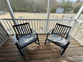 2 metal chairs with cushions.