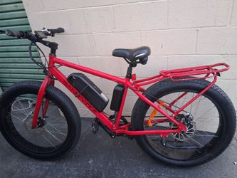 Red electric bike charger included. Bike is fully charged ready to ride.