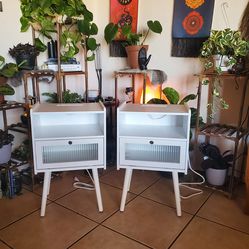 Two white side tables with outlets