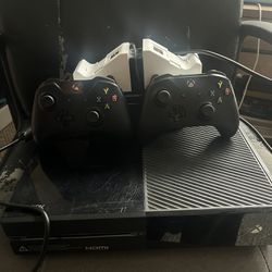 Xbox One , two controllers, wireless charging station, hdmi box and cable
