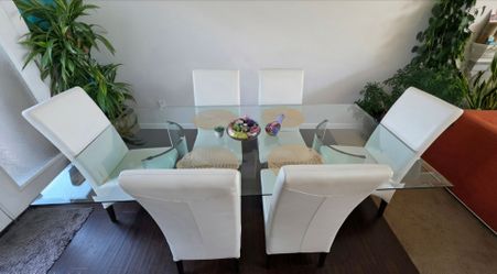 Top Beveled Glass Dining Table With Solid Glass Cresent Shaped Legs. 6 Dania White Leather Chairs. 84"x42"