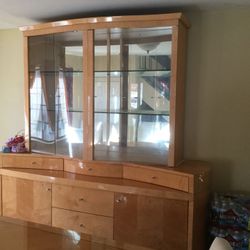 buffet with glass shelves, cabinets, drawers, and mirror