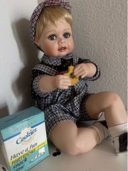 Fine porcelain little boy eating a cookie