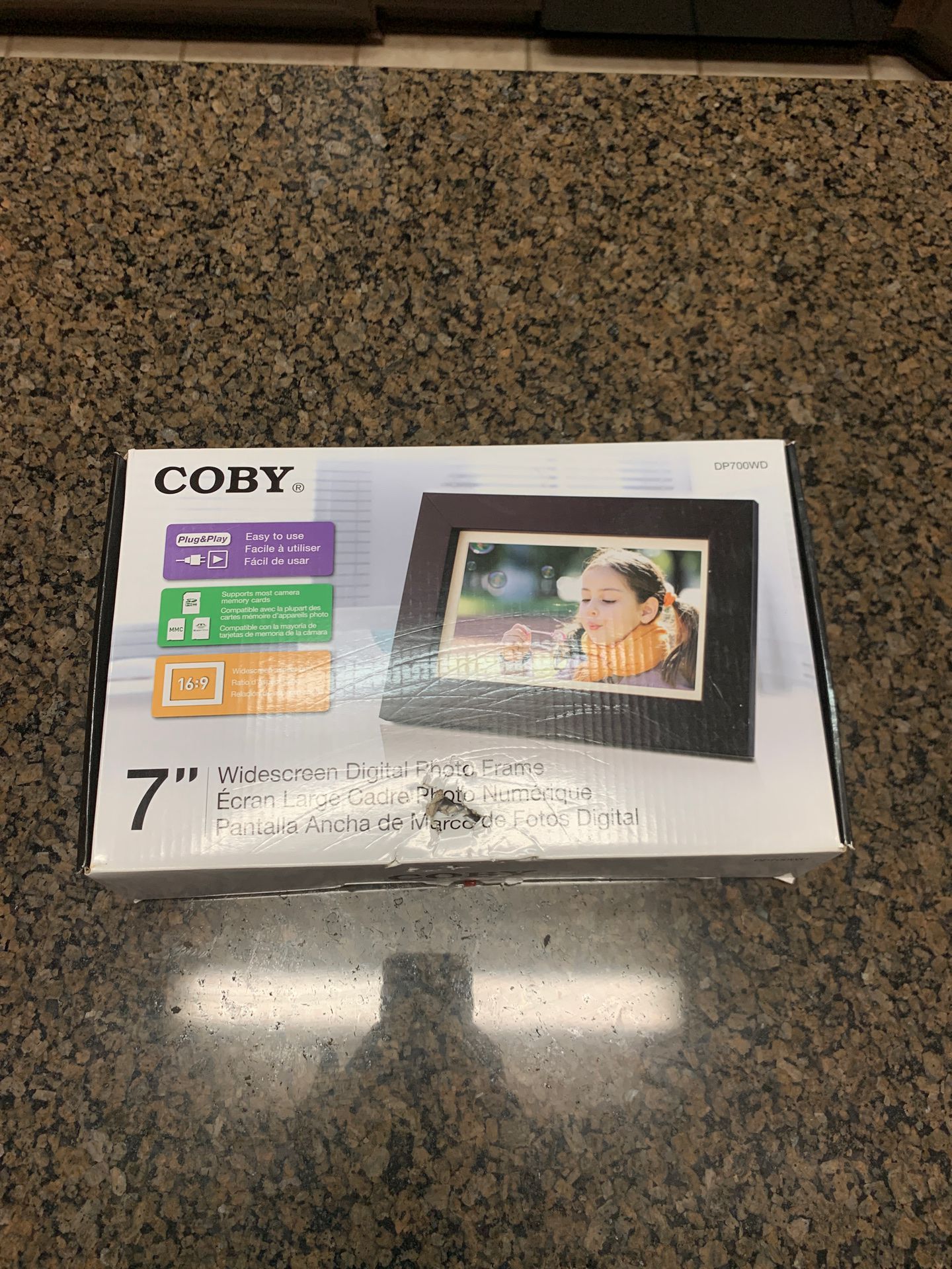 Coby 7” widescreen digital photo frame. New in Box.