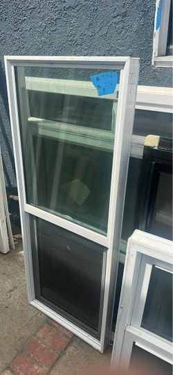Durable white vinyl single-hung window with a built-in screen. This unit measures  23.5 inches in width  59.5 inches in height.  Block window  Cash on