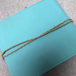 Turquoise Leather Photo Album With A Rope Tie Closure. It Measures 9.5”x9” And Has 40 Pages