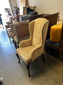 Pair of designer-style lounge/accent chairs featuring elegant floral upholstery, rich wood trim, and a timeless transitional design.  These
