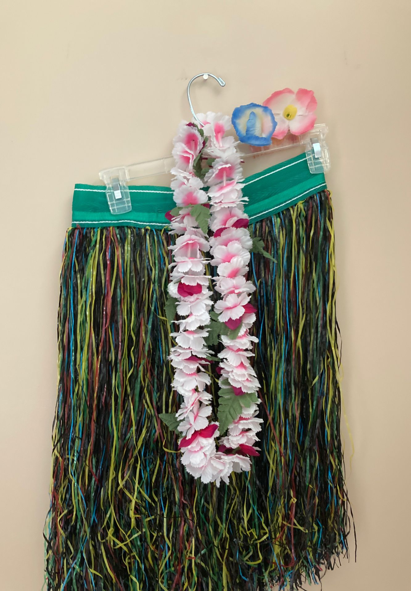 Plastic hula skirt with flower lei and hair flowers