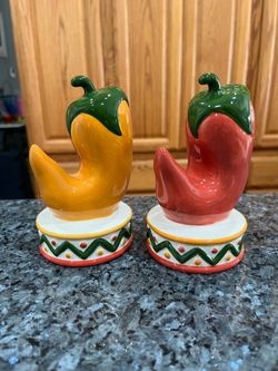 Large Clay Art Ceramic Jalapeno Chili Pair of Salt and Pepper Shaker Set.  Size approximately 5 1/2 inches tall .  Preowned .  Has been on display in 