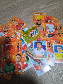 Trading world cup 2026 stickers and 2022 orange background edition ones