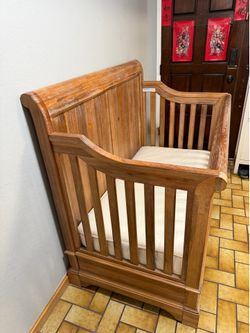This is a Bertini Pembrooke 4-in-1 convertible crib, featured in a rustic wood finish.