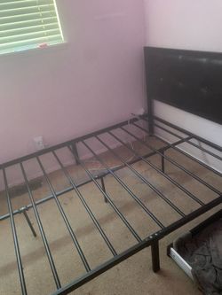 Full size black metal bed frame with faux black leather head board