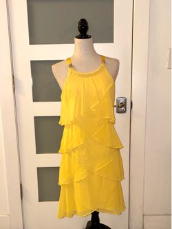 SLNY yellow dress from SL Fashions features a tiered design with ruffles and rhinestone details on the straps.