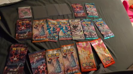Stacked designer jeans and pokemon cards