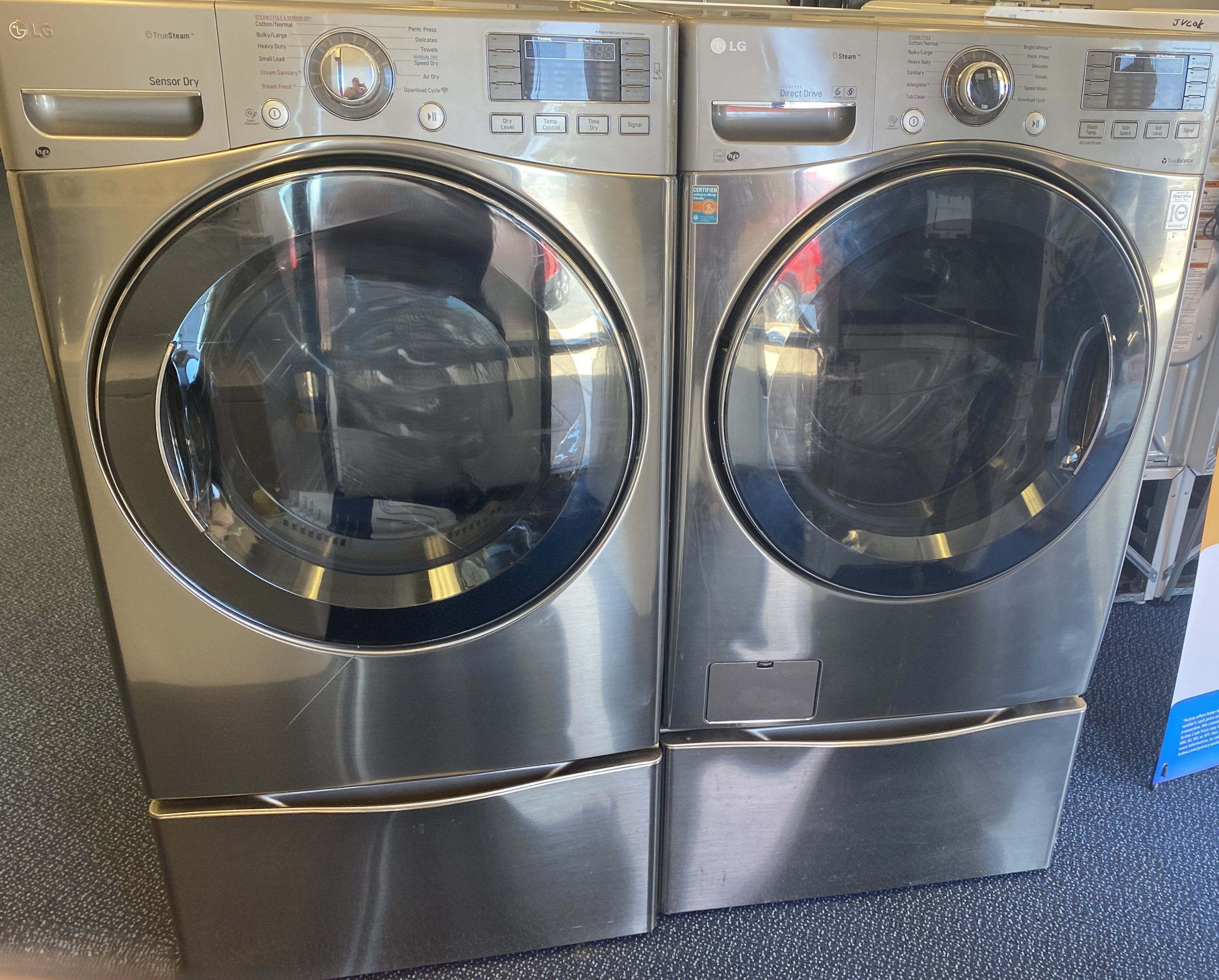 Grey LG Front Load Washing Machine and Electric Dryer Set on Pedestals (0-0047)