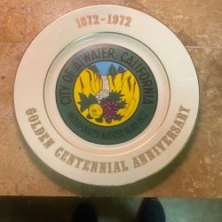 This item is a decorative porcelain plate celebrating the Golden Centennial Anniversary of the City of Atwater, California.     