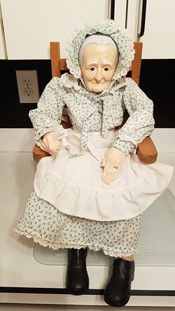 Porcelain grandma doll in rocker