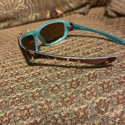 Vintage Oakley Disobey sunglasses, model 05-321, featuring a distinctive brown tortoise shell frame with teal interior