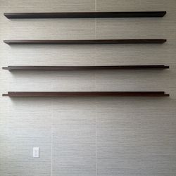 Set of 4 modern floating shelves for sale. Clean, minimalist design with a dark wood finish—great for living rooms, offices, or bedrooms.