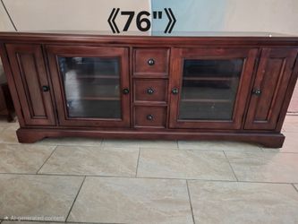 TV stand features a rich mahogany finish