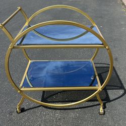 Round gold bar cart with mirrored shelves