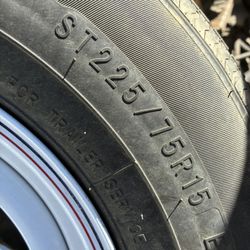Trailer Rim And Tire And A Set Of 20s